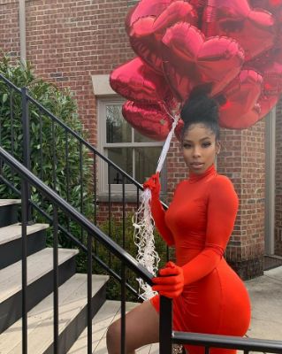 Arionne Curry in red dress